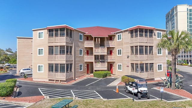 view of property with uncovered parking