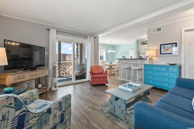 609 Hillside Dr S Unit C-16, North Myrtle Beach, SC 29582 - living room featuring ornamental molding, wood finished floors, and a chandelier