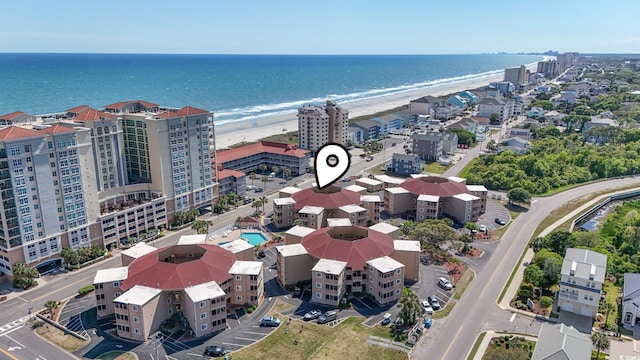 bird's eye view featuring a view of the beach and a water view