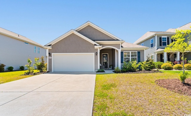 view of front of home with a garage, driveway, and a front lawn