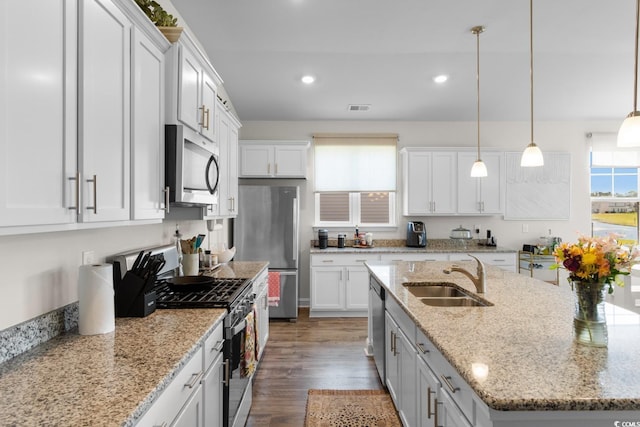 kitchen featuring a sink, stainless steel appliances, and white cabinetry