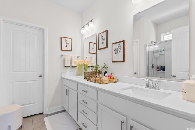 full bathroom featuring a sink, tile patterned flooring, a shower stall, and double vanity