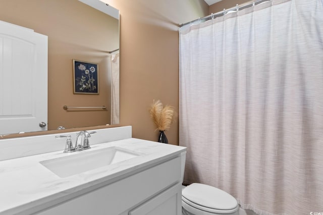 bathroom with vanity, toilet, and a shower with curtain