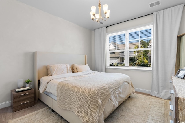 bedroom with baseboards, a notable chandelier, and visible vents