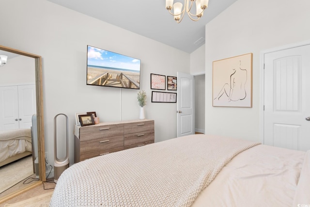 bedroom with a chandelier, light carpet, vaulted ceiling, and a closet