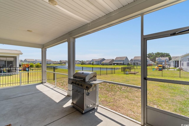 view of patio featuring a fenced backyard, grilling area, and a residential view