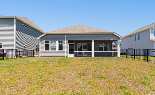 back of property with a sunroom, a fenced backyard, and a lawn