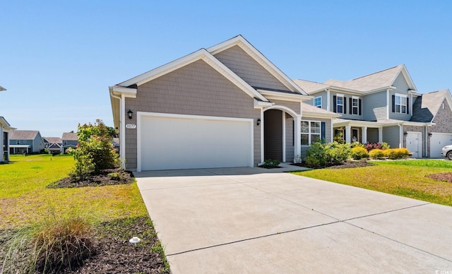 view of front of property with a garage, concrete driveway, and a front lawn
