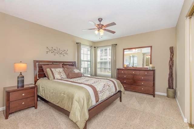 bedroom with baseboards, a ceiling fan, and light colored carpet