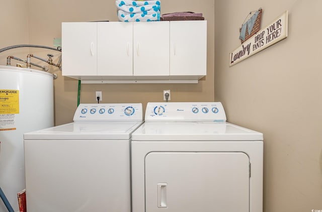 laundry room featuring water heater, cabinet space, and washer and dryer