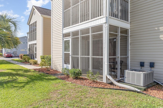 view of property exterior featuring a yard and central AC