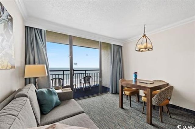 1105 S Ocean Blvd Unit 630, Myrtle Beach, SC 29577 - living area featuring a water view, a textured ceiling, expansive windows, ornamental molding, and a chandelier
