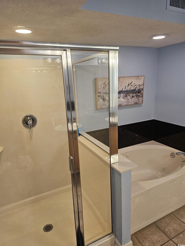 full bathroom with a whirlpool tub, a shower stall, a textured ceiling, tile patterned flooring, and recessed lighting