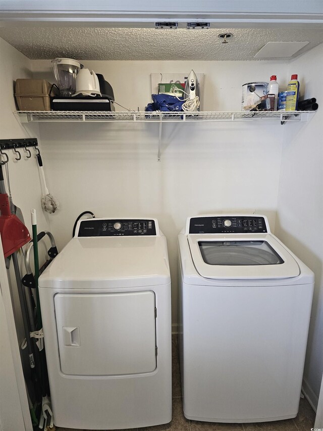 clothes washing area with washer and dryer
