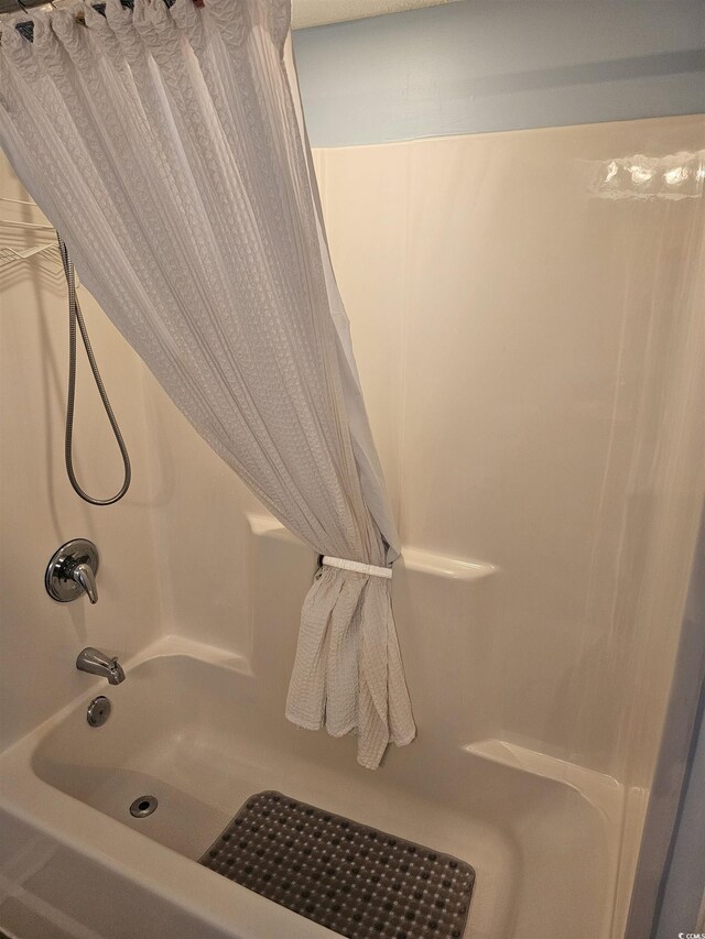 full bathroom with shower / bath combination with curtain