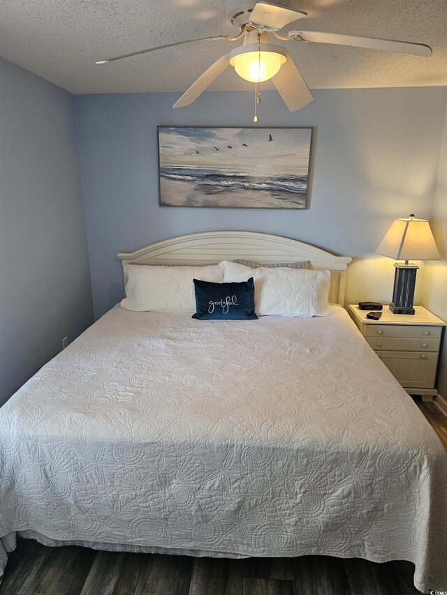 bedroom featuring wood finished floors, a textured ceiling, and ceiling fan
