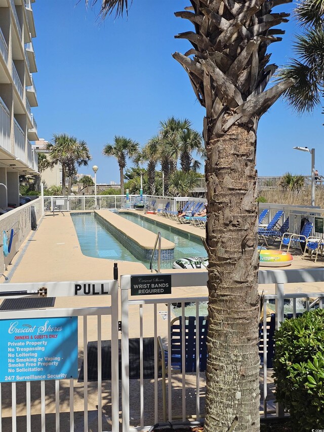 community pool featuring fence