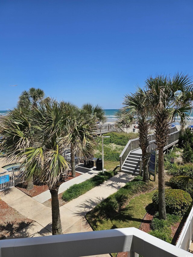 view of property's community with view of water and beach