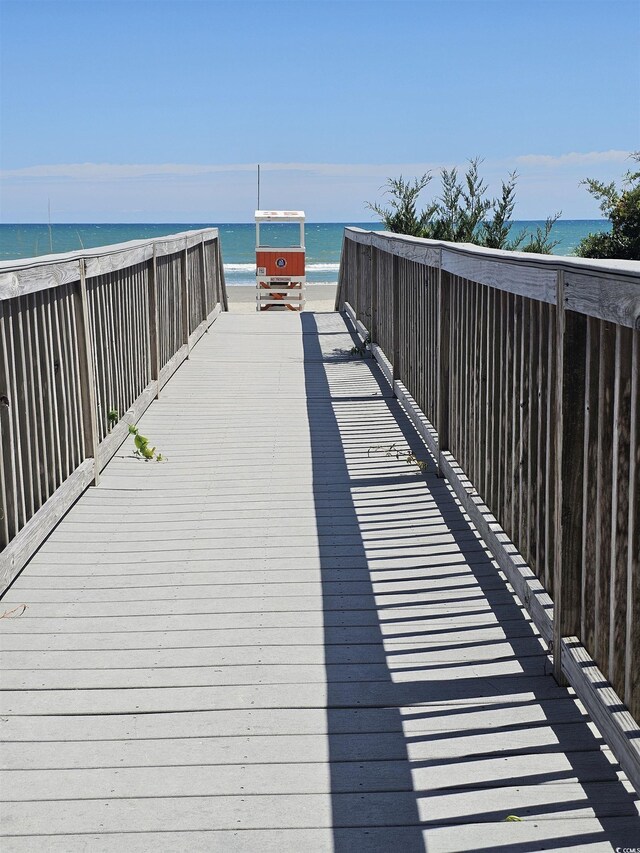 view of home's community with view of water and beach