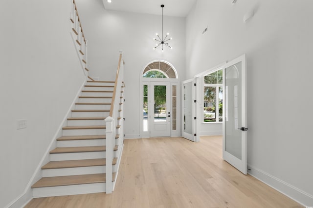 985 Shipmaster Ave, Myrtle Beach, SC 29579 - entrance foyer with light wood-style floors, a towering ceiling, stairs, and a chandelier