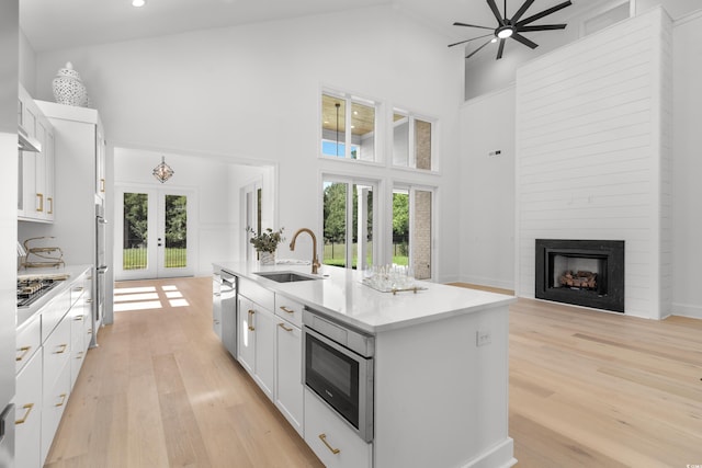 985 Shipmaster Ave, Myrtle Beach, SC 29579 - kitchen with french doors, appliances with stainless steel finishes, a center island with sink, a sink, and high vaulted ceiling