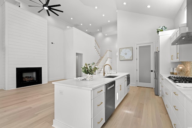 985 Shipmaster Ave, Myrtle Beach, SC 29579 - kitchen featuring a high ceiling, a center island with sink, wall chimney exhaust hood, a sink, and stainless steel appliances