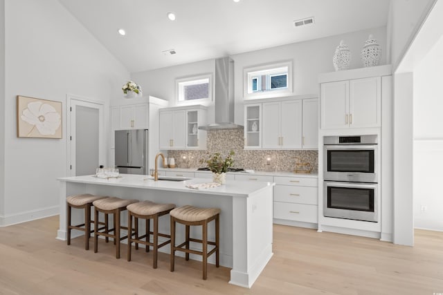 985 Shipmaster Ave, Myrtle Beach, SC 29579 - kitchen with appliances with stainless steel finishes, a sink, an island with sink, wall chimney exhaust hood, and decorative backsplash