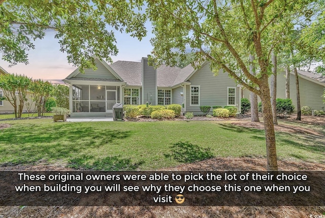 156 Summerlight Dr, Murrells Inlet, SC 29576 - rear view of property with a sunroom, a yard, a chimney, and roof with shingles