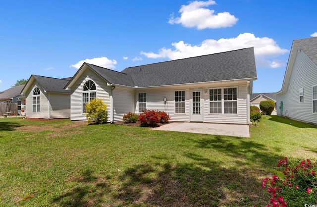 back of house with a yard and a patio