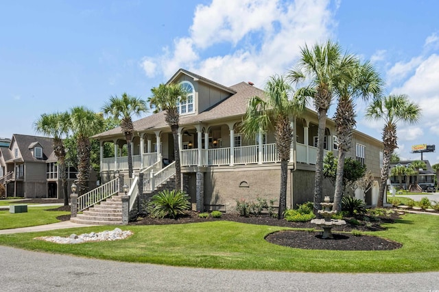 view of front of home featuring stairs, a porch, and a front lawn
