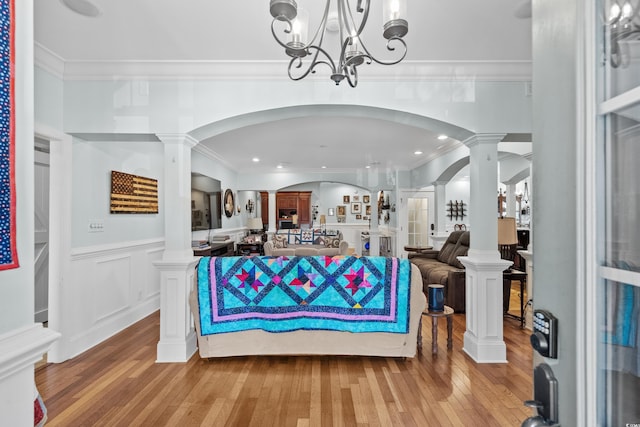 reception area featuring ornate columns, arched walkways, and a notable chandelier