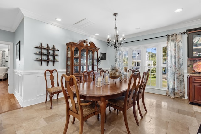 dining space with crown molding, a chandelier, a wainscoted wall, and recessed lighting