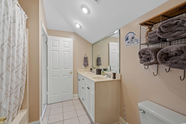 full bath with toilet, vanity, vaulted ceiling, tile patterned flooring, and baseboards