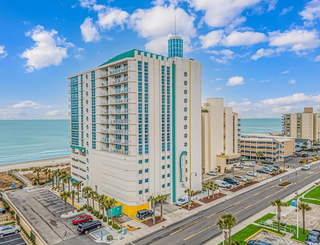 view of property with a water view and uncovered parking
