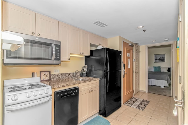 kitchen with a sink, recessed lighting, light tile patterned floors, visible vents, and black appliances