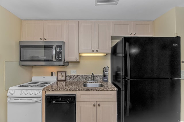 kitchen featuring stone countertops, visible vents, a sink, and black appliances