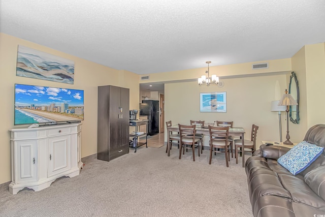 2301 S Ocean Blvd Unit 1202, North Myrtle Beach, SC 29582 - living area featuring a chandelier, light carpet, and a textured ceiling