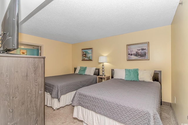 carpeted bedroom featuring a textured ceiling