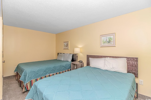 bedroom featuring carpet flooring and a textured ceiling