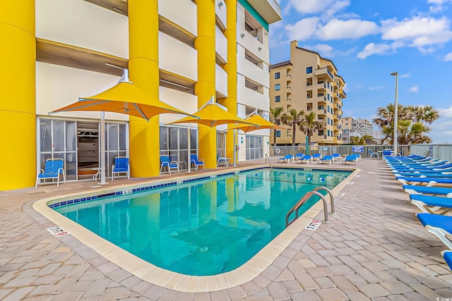 pool featuring a patio and fence