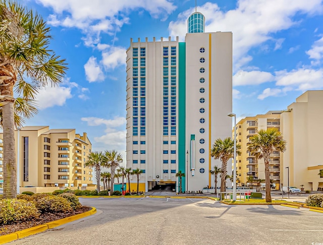 view of building exterior with uncovered parking