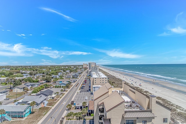 drone / aerial view featuring a beach view and a water view