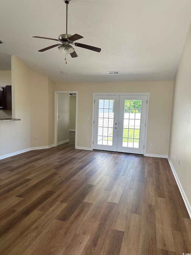 unfurnished room with ceiling fan, french doors, baseboards, dark wood-type flooring, and visible vents
