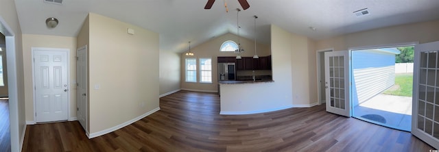 interior space featuring stainless steel fridge, visible vents, a ceiling fan, dark wood-type flooring, and vaulted ceiling