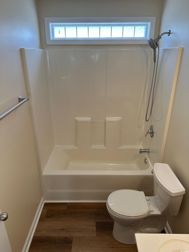full bath featuring toilet, shower / washtub combination, wood finished floors, and vanity