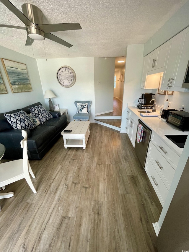 625 N Waccamaw Dr Unit 101, Murrells Inlet, SC 29576 - living area featuring wood finished floors, a textured ceiling, a ceiling fan, and baseboards
