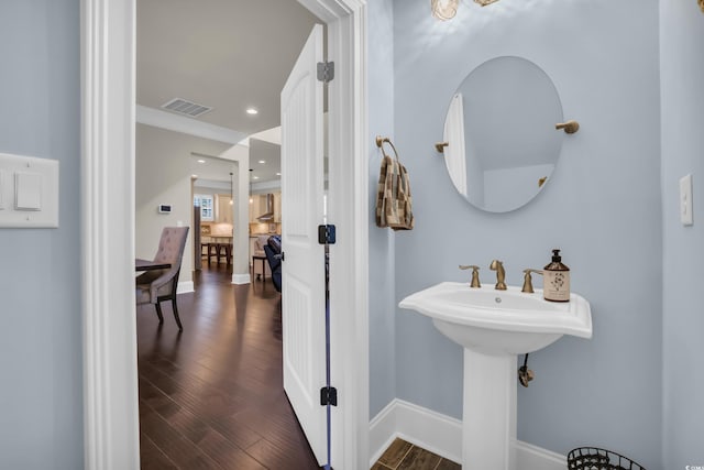 bathroom with baseboards, recessed lighting, wood finished floors, and visible vents