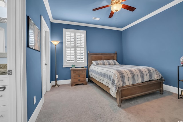 carpeted bedroom with crown molding, baseboards, and visible vents