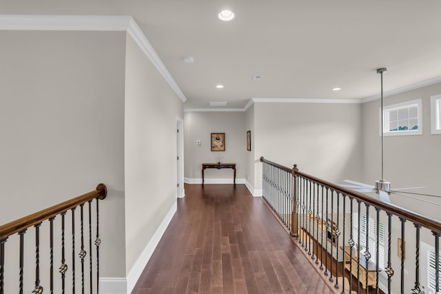 hallway with crown molding, recessed lighting, baseboards, and wood finished floors