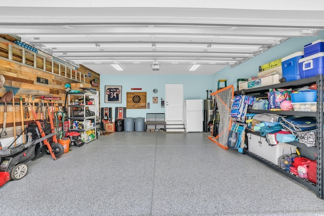 garage featuring freestanding refrigerator and a garage door opener